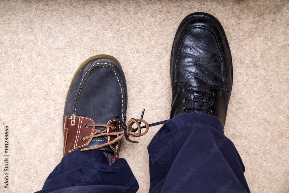 April Fool's Day Shoes. An odd pair of men's shoes with the laces tied  together. foto de Stock | Adobe Stock