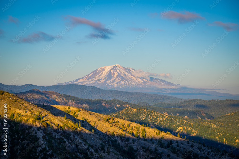 Fototapeta premium The breathtaking views of the volcano at sunset. The last rays of the sun illuminate a large crater. Mount Adams, view from Windy Ridge Trail