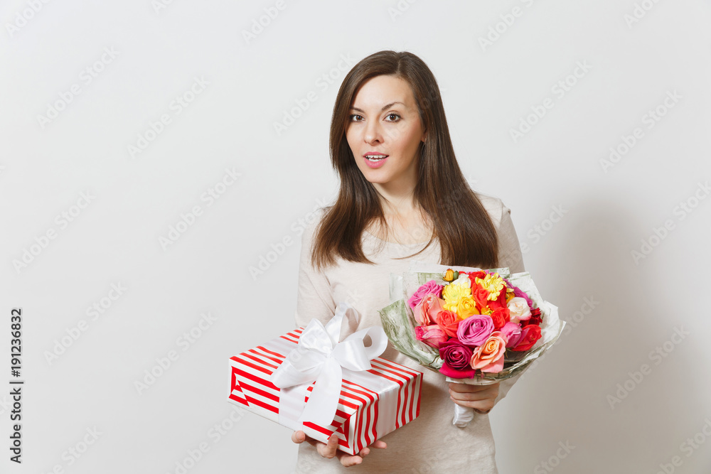 Young pretty woman holding bouquet of beautiful roses flowers, present box with gift isolated on white background. Copy space for advertisement. St. Valentines Day or International Women's Day concept Young pretty woman holding bouquet of beautiful roses flowers, present box with gift isolated on white background. Copy space for advertisement. St. Valentines Day or International Women's Day concept