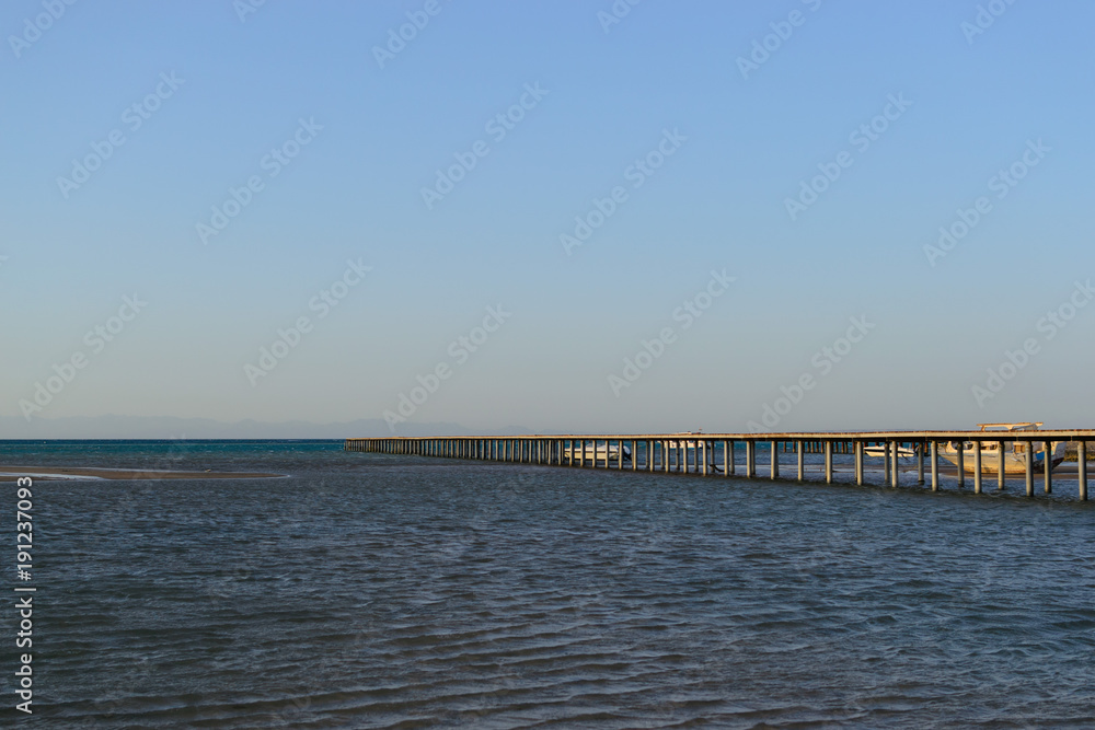 Long pier in the sea evening