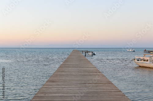 Wood bridge pier against beautiful sunset sky © SolaruS