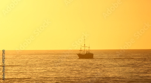 pirate ship sailing into golden sunset © Joanne