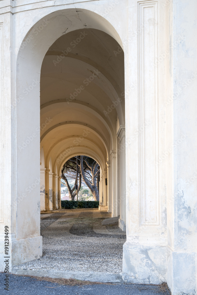 Gallery of arches, ancient church portico with sunset light