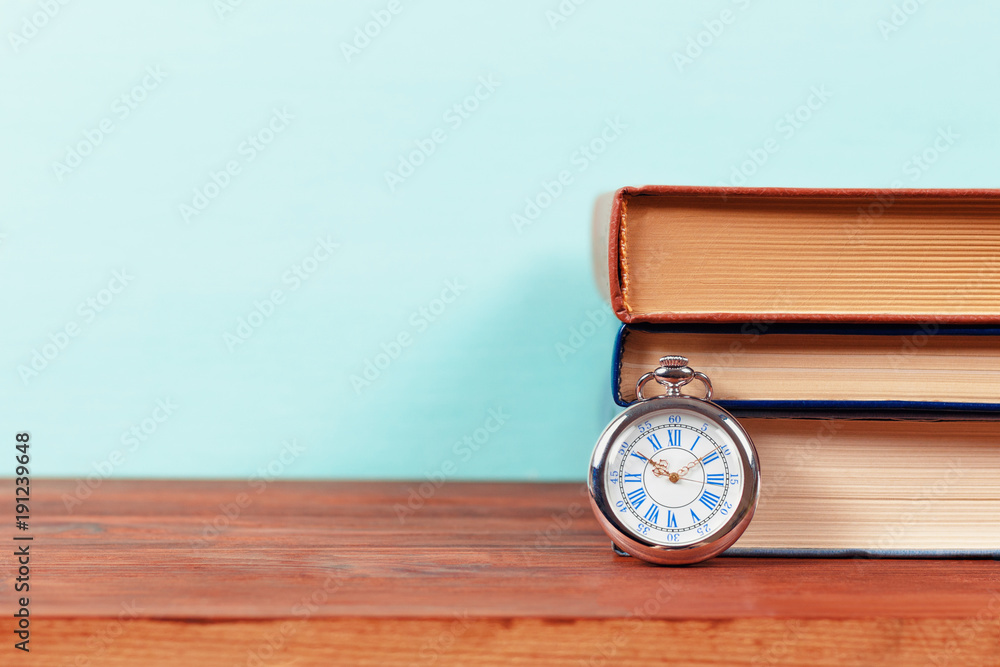 Old pocket watch with old books Old pocket watch with old books