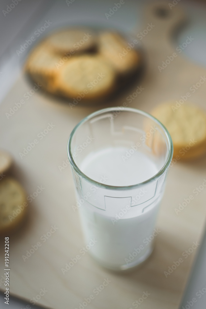 miscellaneous cookies, next to milk on a soft light background miscellaneous cookies, next to milk on a soft light background