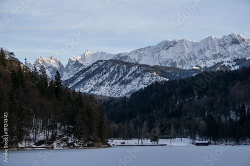 Frozen alpine lake in the mountains of Austria with beautiful peaks setting the backdrop
