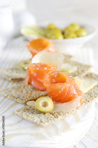 Delicious appetizer canapes with salmon and cheese. photo