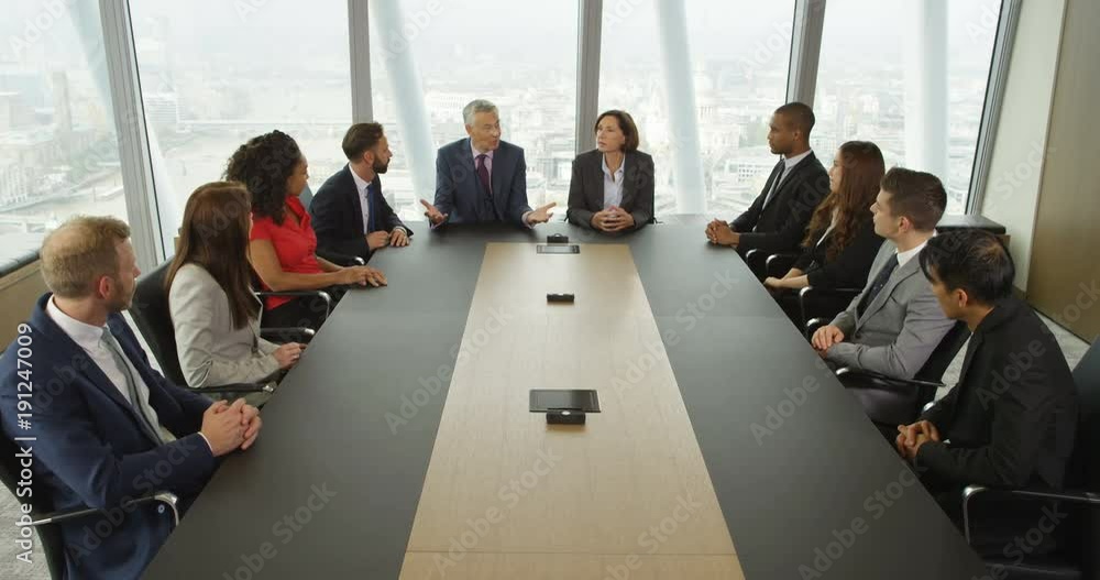 4k, Large group of multi ethnic business people in a board room meeting with London skyline in the background. Slow motion.