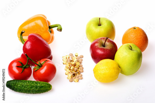 Omega 3 capsules, apples, citruses and vegetables.