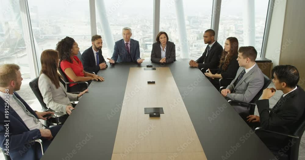4k, Large group of multi ethnic business people during a corporate boardroom meeting. Slow motion.