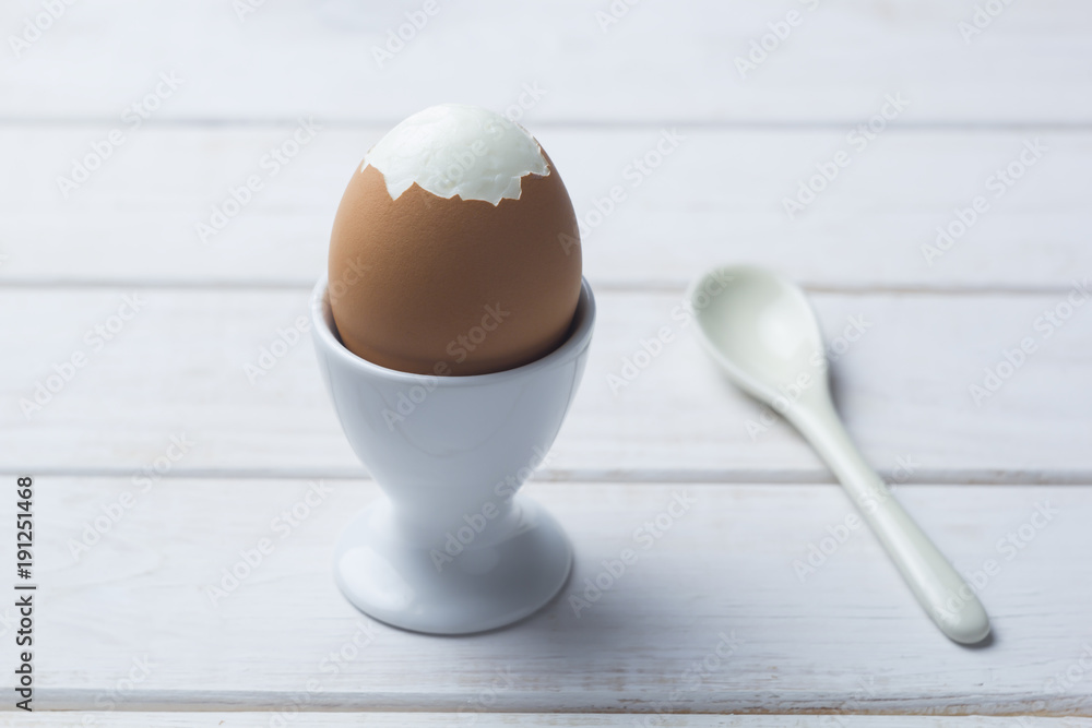 Boiled egg with a spoon.