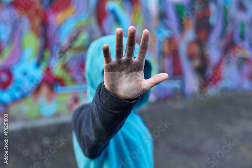 dramatic portrait of a little homeless boy, dirty hand