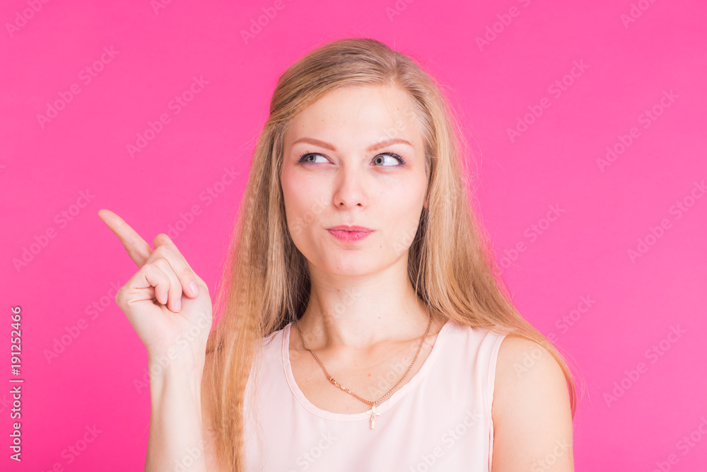 Studio portrait of beautiful young woman thinking and looking aside. Studio portrait of beautiful young woman thinking and looking aside.