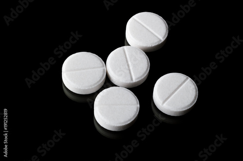 Group of different tablets on black background with reflection