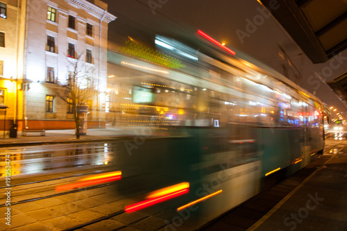 The motion of a blurred tram on the street at dusk