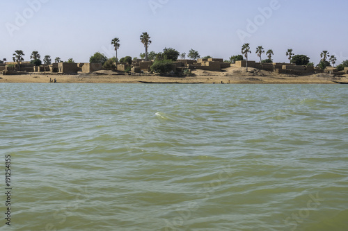 Mud houses along the shores of the Niger River, Mali photo