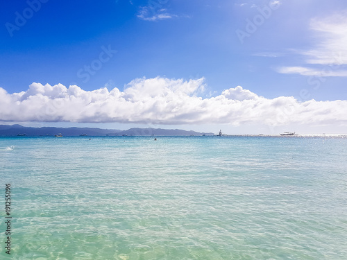 white sand, ocean and blue sky, tropical island in the Pacific Ocean