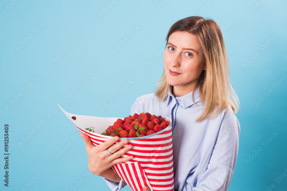 Beautiful woman holding bouquet made of strawberry Beautiful woman holding bouquet made of strawberry