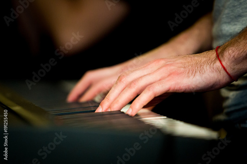 Close up male hands playing electric piano