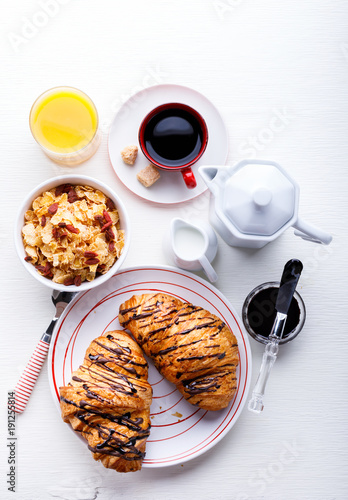 Croissant with Chocolate Espresso with milk and a glass of orange juice Tradition Dry Dry with goji berries Morning Baking sweet Dessert on the White Background