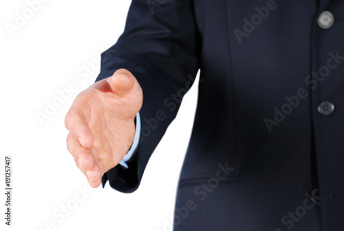 Closeup of a businessman in suit giving hand for handshake
