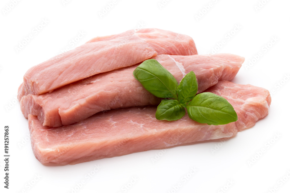 Fresh pork fillet with basil on a white background. Fresh pork fillet with basil on a white background.
