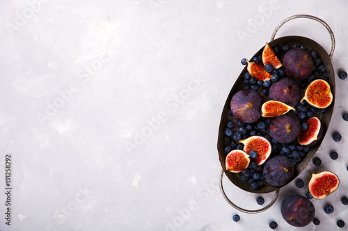 Figs and Blueberries on a light background. Autumn Berry. Food. Vegetarian.Top View.Copy space for Text. selective focus.