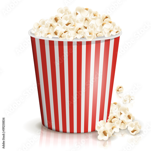 A full red-and-white striped bucket of fluffy popcorn isolated on the white background. Vector illustration. Popcorn fallen from cardboard or paper bucket. Cinema snack and movie food.
