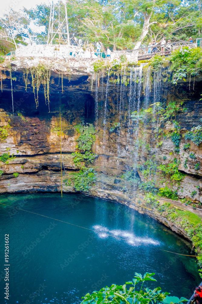 Fototapeta premium Ik-Kil Cenote near Chichen Itza, Mexico. Lovely cenote with transparent waters and hanging roots