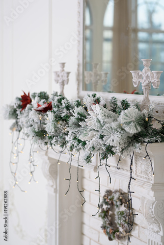 Fototapeta Naklejka Na Ścianę i Meble -  Christmas decor on a white fireplace. White background.