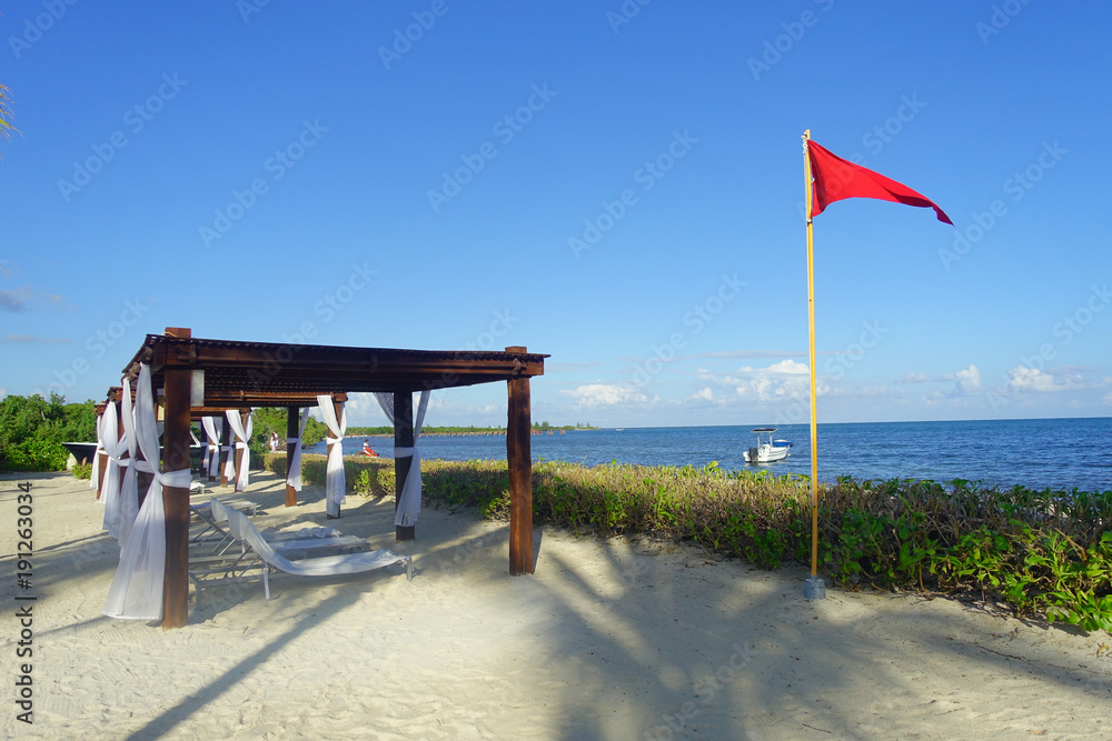 Outdoor view of beautiful huts located along the beach in PLaya del Carmen at Caribbean Sea in Mexico Outdoor view of beautiful huts located along the beach in PLaya del Carmen at Caribbean Sea in Mexico