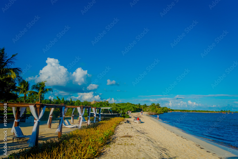 Outdoor view of beautiful huts located along the beach in PLaya del Carmen at Caribbean Sea in Mexico