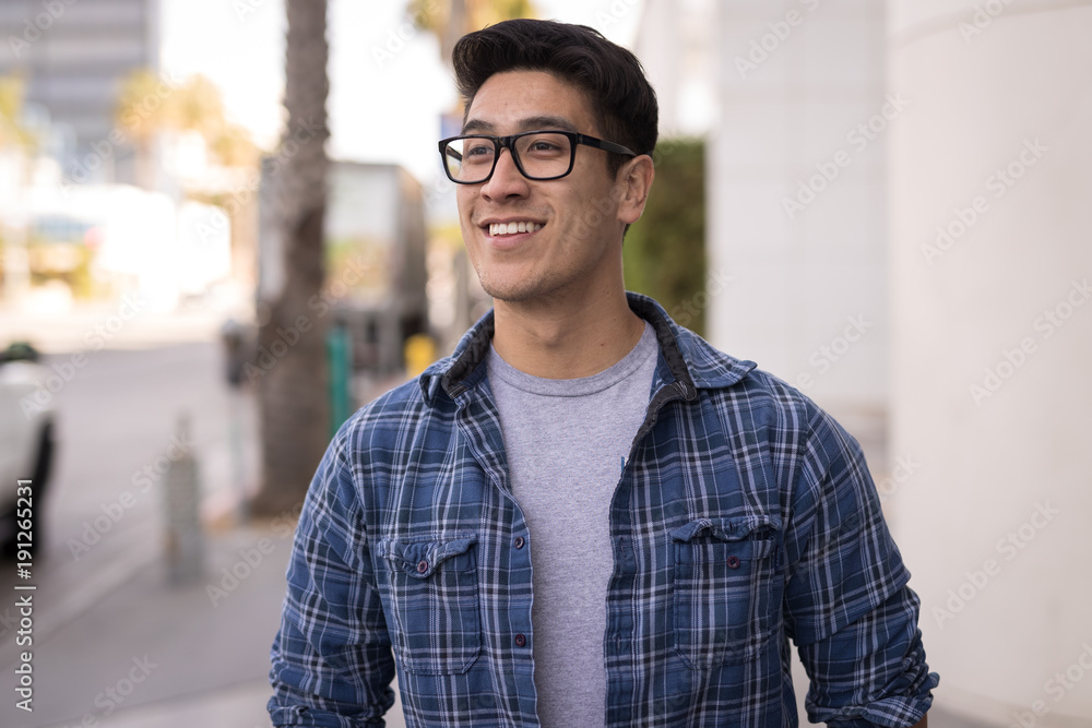 Young Asian man walking street smile happy Young Asian man walking street smile happy