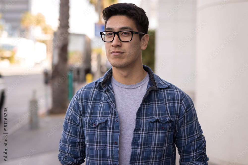 Young Asian man walking street serious face Young Asian man walking street serious face