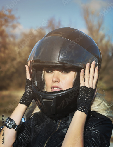 Beautiful biker woman outdoor      © Alona