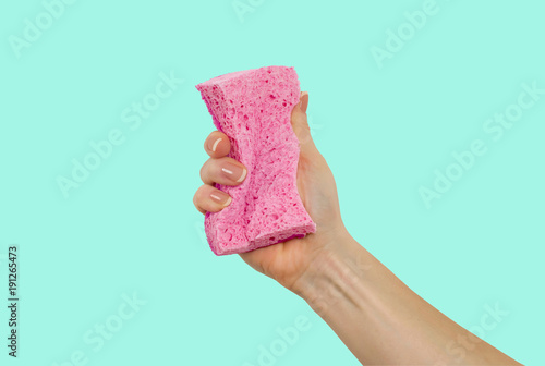 Woman's hand, holding a sponge for dishes photo