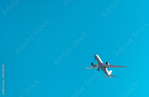 Big white plane flying in a blue sky
