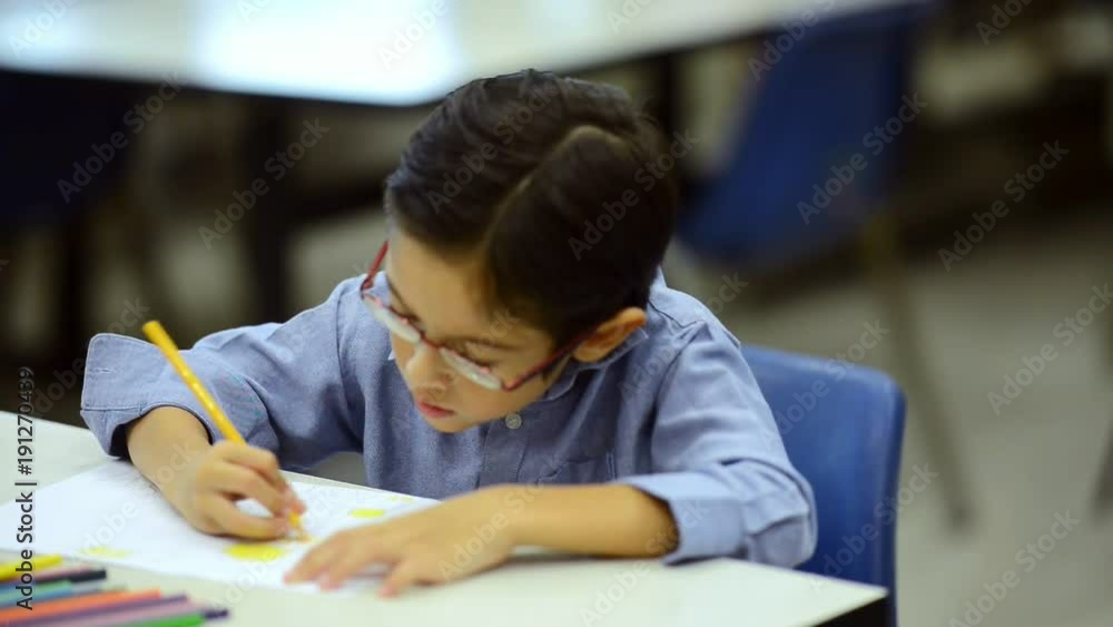 Small children study with teacher. Young boy drawing on table. Education concept. Small children study with teacher. Young boy drawing on table. Education concept.