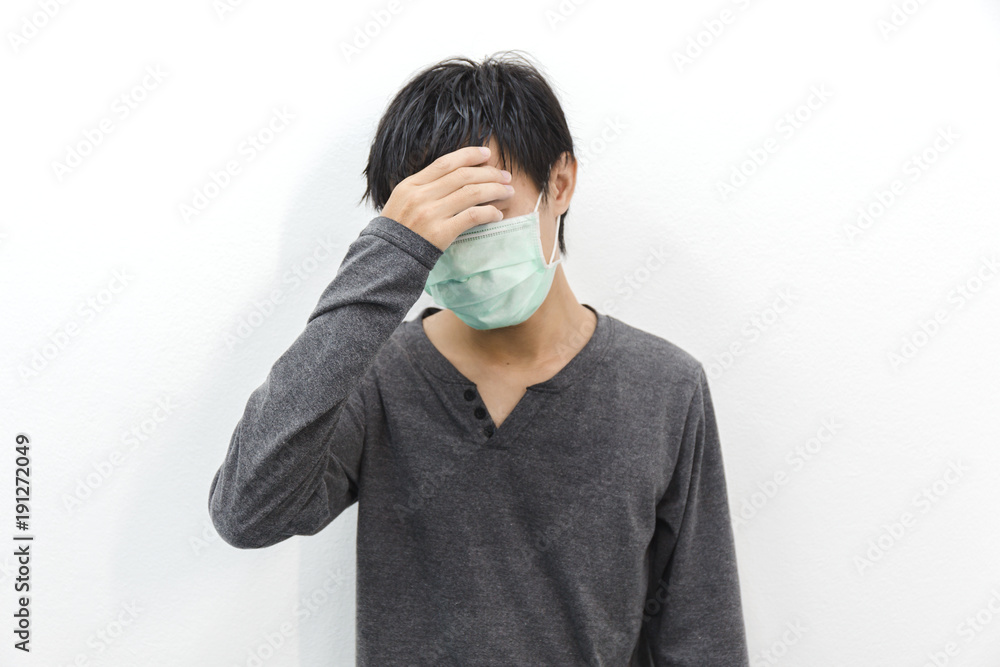 Men with migraine headache fever and dust mask. Men with migraine headache fever and dust mask.