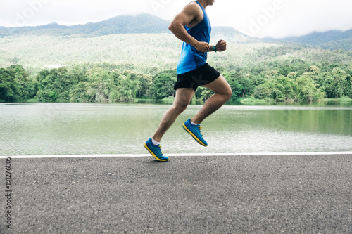 man runner jogger running at lake view in the morning