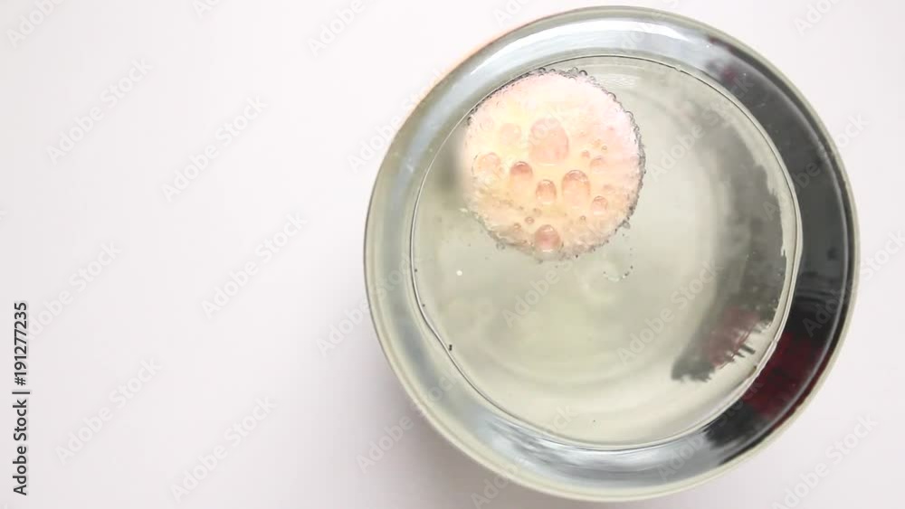 Vitamin tablet dissolves in large water glass Vitamin tablet dissolves in large water glass