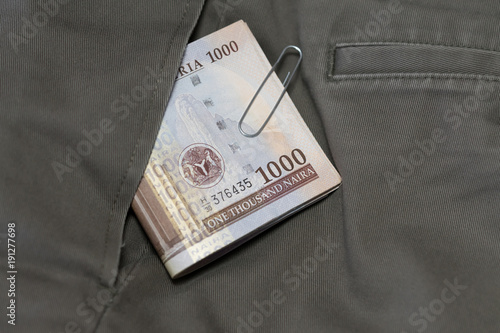 Bundle of Naira Notes Falling from Pants Pocket