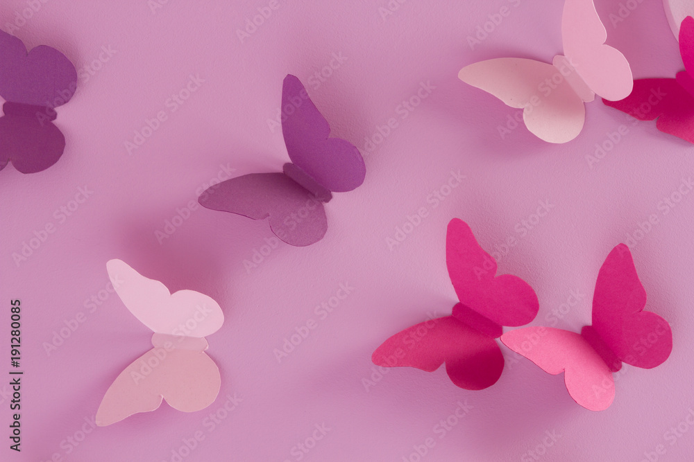 Paper butterflies on a pink background. Love and Valentine's day concept. Top view Paper butterflies on a pink background. Love and Valentine's day concept. Top view