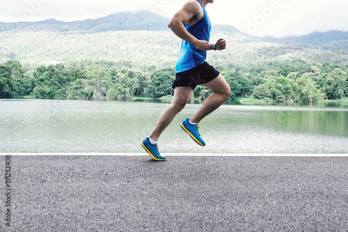 man runner jogger running at lake view in the morning