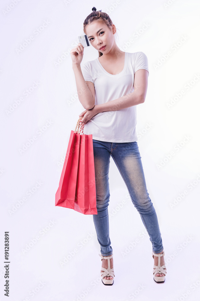 pretty woman with shopping bags holding credit card on bright background. pretty woman with shopping bags holding credit card on bright background.