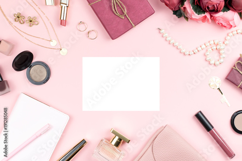 Woman fashion accessories, flowers, cosmetics and jewelry on pink background, copyspace. Womens Day concept
