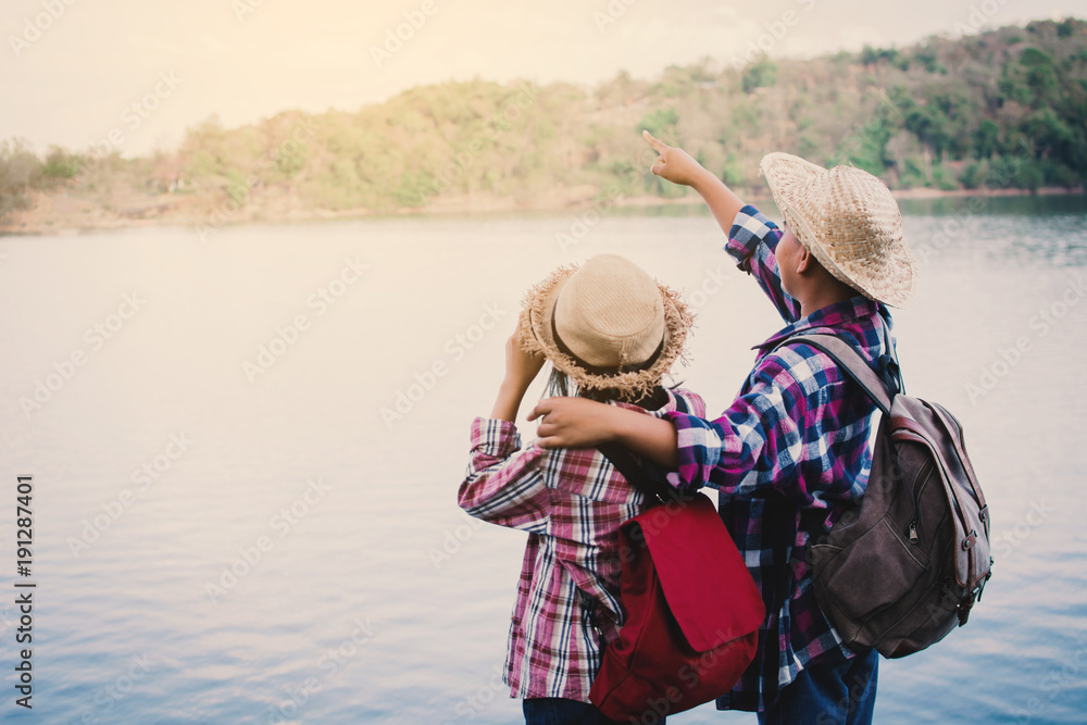 Asian girl and boy backpack in nature , Relax time on holiday concept travel,selective and soft focus,tone of hipster style