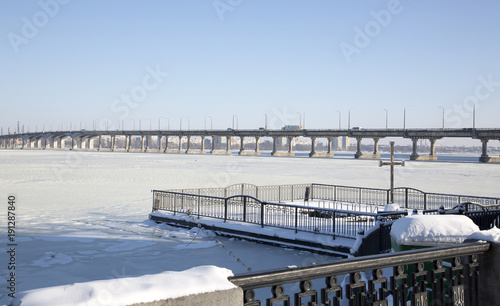 The river Dnieper is covered with ice and a view of the bridge over the river © i_valentin