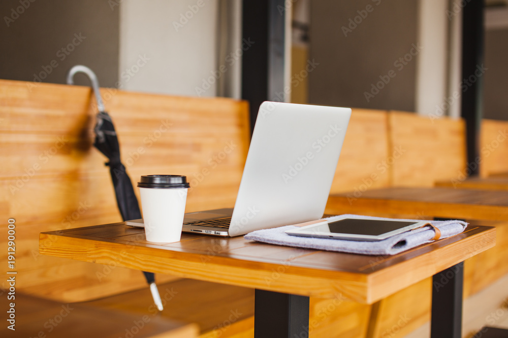 Modern equipment on wooden table at cafe. Open laptop Modern equipment on wooden table at cafe. Open laptop