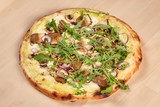 Fresh baked pizza with mushrooms on wooden background